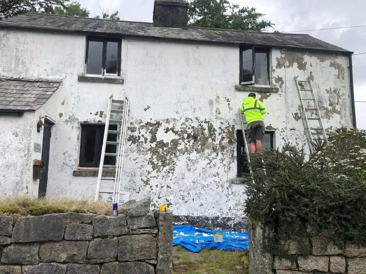 Cottage with blown, flaking render before repair in Northam